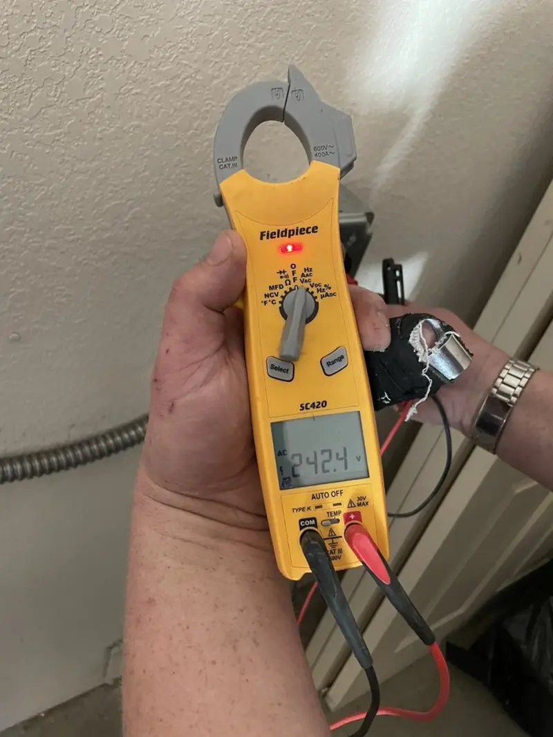 Voltage testing with clamp meter during Electrical Installation Services in Freetown